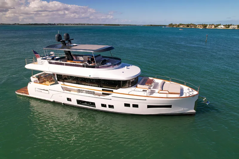 Slide: The Image of Luxury Sirena 68 yacht cruising on clear blue waters, 2023 model. - 2