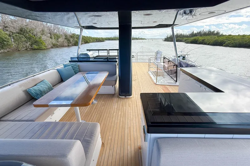 Slide: The Image of Luxurious 2023 Sirena 68 yacht deck with elegant seating and scenic river view. - 22