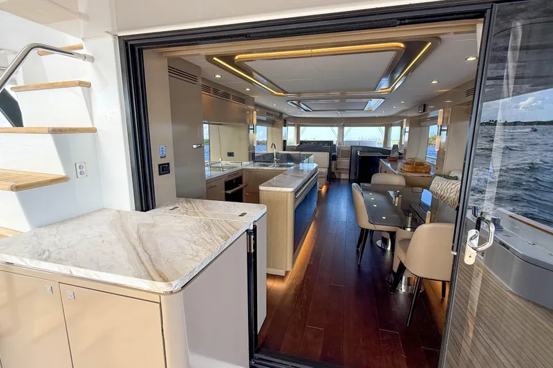 Slide: The Image of Luxurious interior of 2023 Sirena 68 yacht with modern dining and kitchen area. - 24