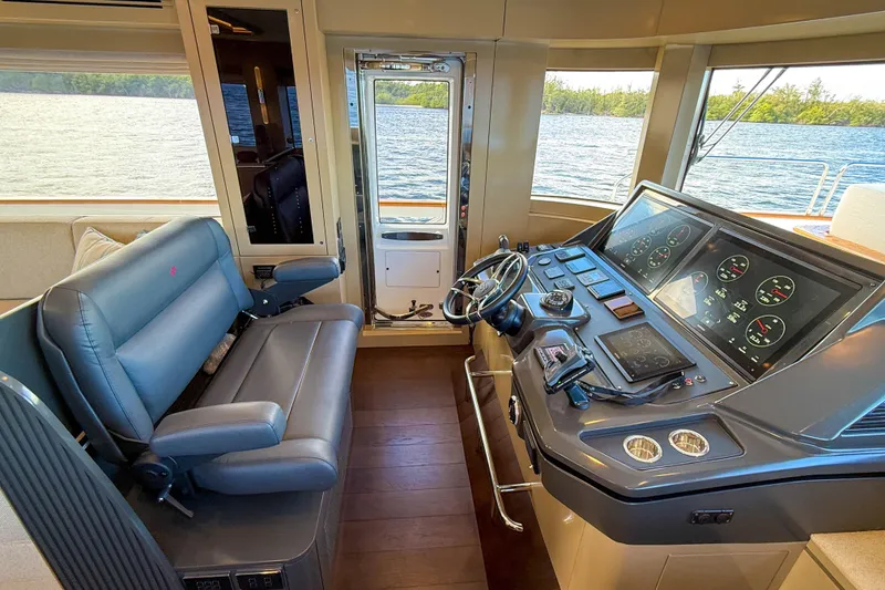 Slide: The Image of Interior helm of 2023 Sirena 68 yacht with modern navigation controls and leather seating. - 35