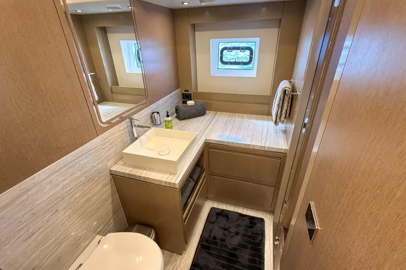 Slide: The Image of Luxurious bathroom interior of 2023 Sirena 68 yacht with modern fixtures and wooden cabinetry. - 44