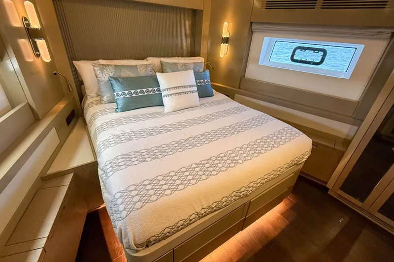 Slide: The Image of Luxurious bedroom interior of 2023 Sirena 68 yacht with elegant bedding and ambient lighting. - 49