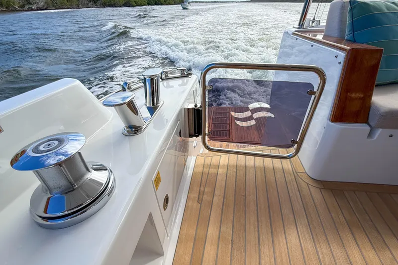 Slide: The Image of Luxury Sirena 68 yacht deck with chrome fittings, 2023 model, cruising on water. - 57