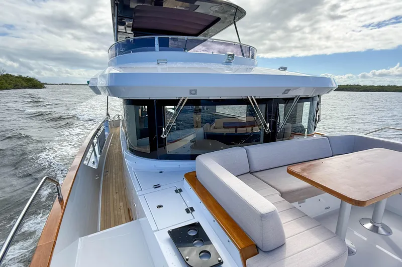 Slide: The Image of Luxurious 2023 Sirena 68 yacht cruising on open water with elegant seating area. - 62