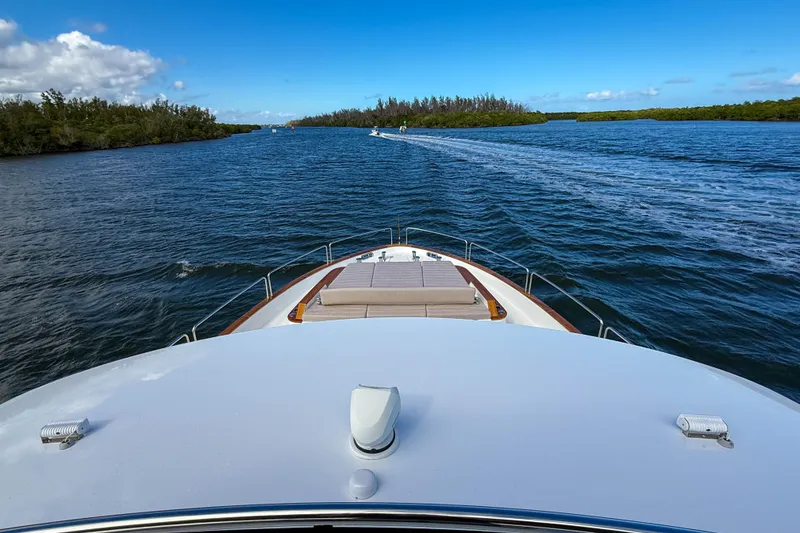 Slide: The Image of Bow view of 2023 Sirena 68 yacht cruising through scenic waters. - 72