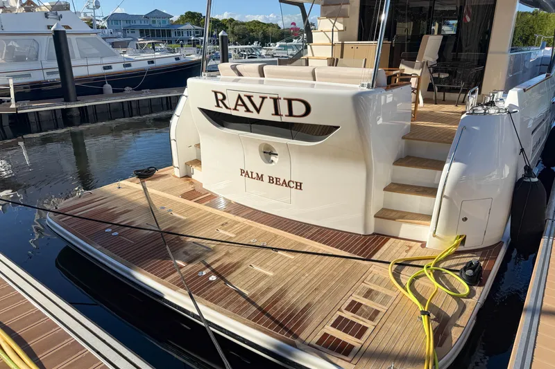 Slide: The Image of Luxury Sirena 68 yacht docked, featuring elegant teak decking, 2023 model. - 8