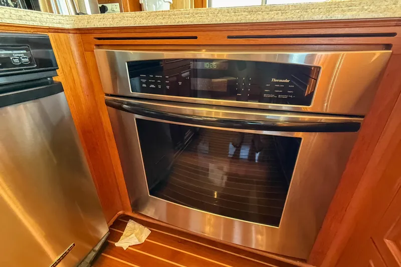 Slide: The Image of Thermador oven in 2003 Grand Banks 64 Aleutian RP yacht kitchen, featuring wood cabinetry. - 18