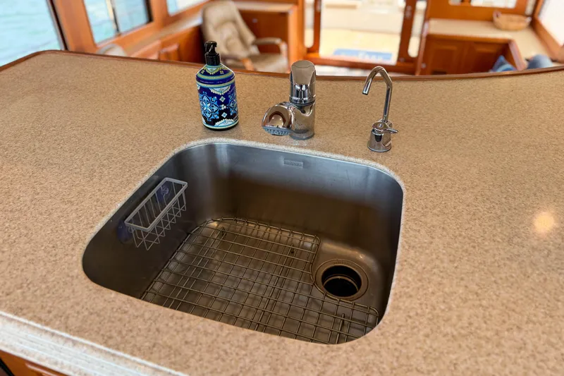 Slide: The Image of Luxury yacht kitchen sink on 2003 Grand Banks 64 Aleutian RP with elegant countertop. - 19
