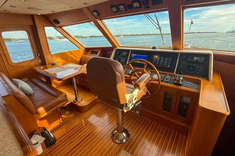 Slide: The Image of Luxurious 2003 Grand Banks 64 Aleutian RP yacht interior with wooden helm and seating area. - 20