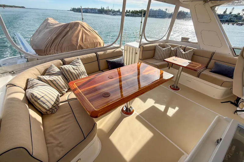 Slide: The Image of Luxurious 2003 Grand Banks 64 Aleutian RP yacht interior with elegant wood table and plush seating. - 28