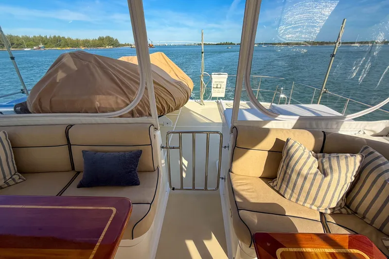 Slide: The Image of 2003 Grand Banks 64 Aleutian RP yacht deck with covered equipment, cruising on a sunny day. - 34