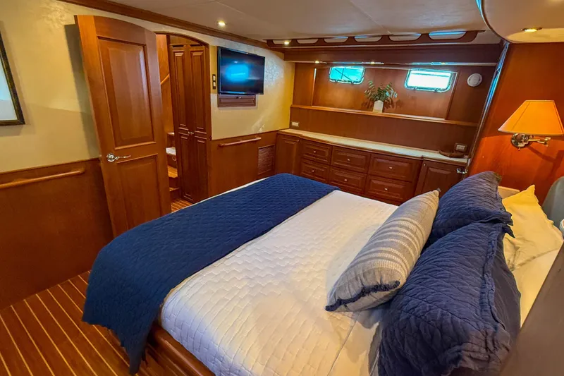 Slide: The Image of Luxurious bedroom on 2003 Grand Banks 64 Aleutian RP yacht with elegant wood finish. - 45