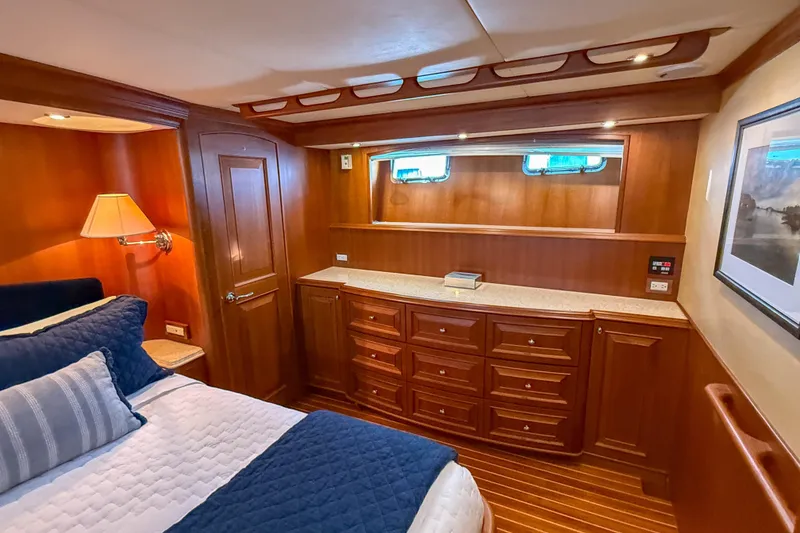 Slide: The Image of Luxurious cabin interior of 2003 Grand Banks 64 Aleutian RP yacht, featuring wood paneling and elegant decor. - 46