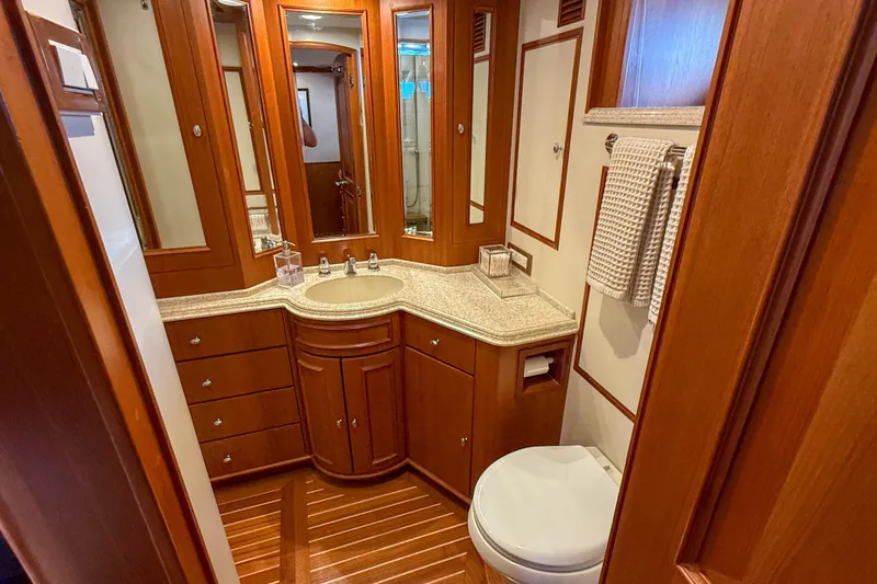 Slide: The Image of Luxurious shower area in 2003 Grand Banks 64 Aleutian RP yacht with glass door and wooden accents. - 50