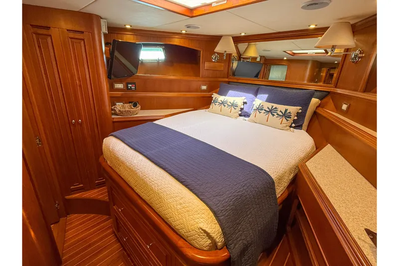 Slide: The Image of Luxurious cabin interior of 2003 Grand Banks 64 Aleutian RP yacht, featuring elegant wood finishes. - 54