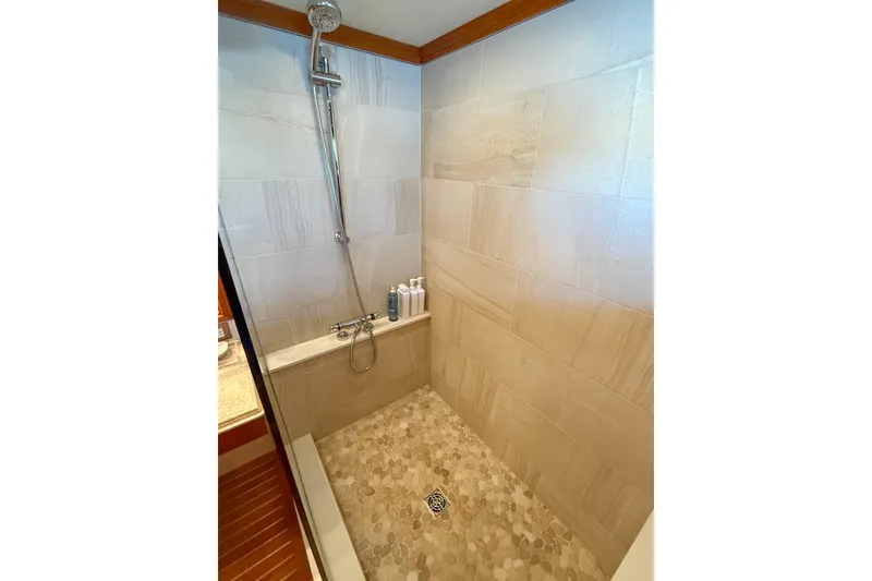 Slide: The Image of Luxurious bathroom on 2003 Grand Banks 64 Aleutian RP yacht with shower and wooden accents. - 57