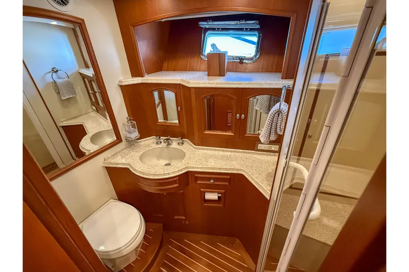 Slide: The Image of Shower area in 2003 Grand Banks 64 Aleutian RP yacht, featuring wooden flooring and modern fixtures. - 62