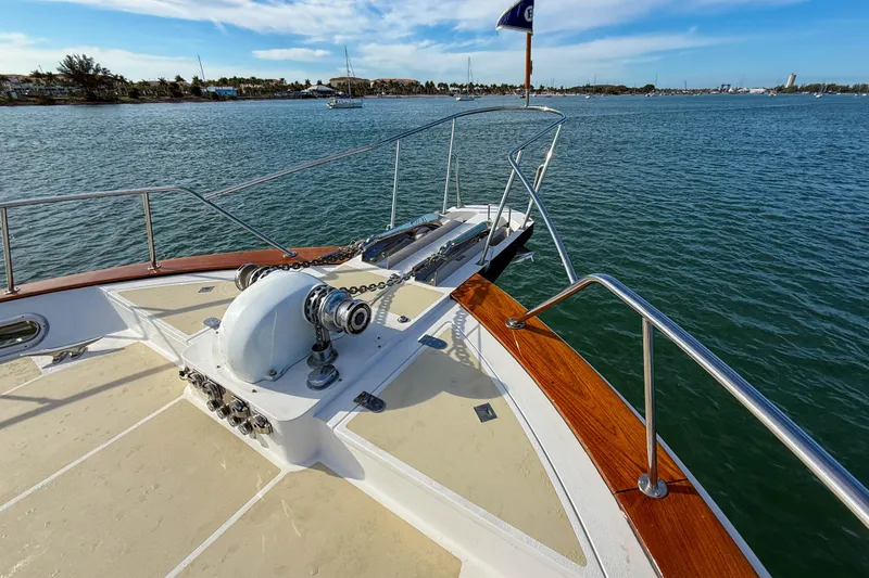 Slide: The Image of 2003 Grand Banks 64 Aleutian RP yacht on calm water, spacious deck view. - 70