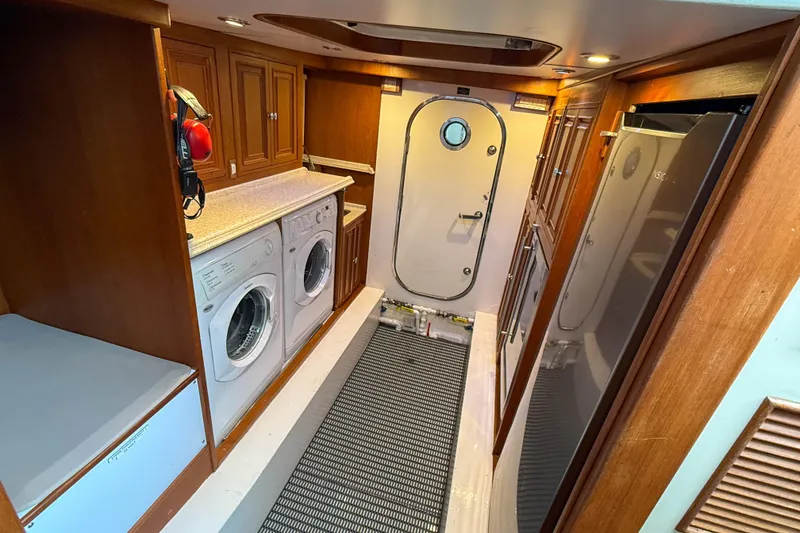 Slide: The Image of 2003 Grand Banks 64 Aleutian RP yacht interior with wooden cabinets and stainless steel appliances. - 74