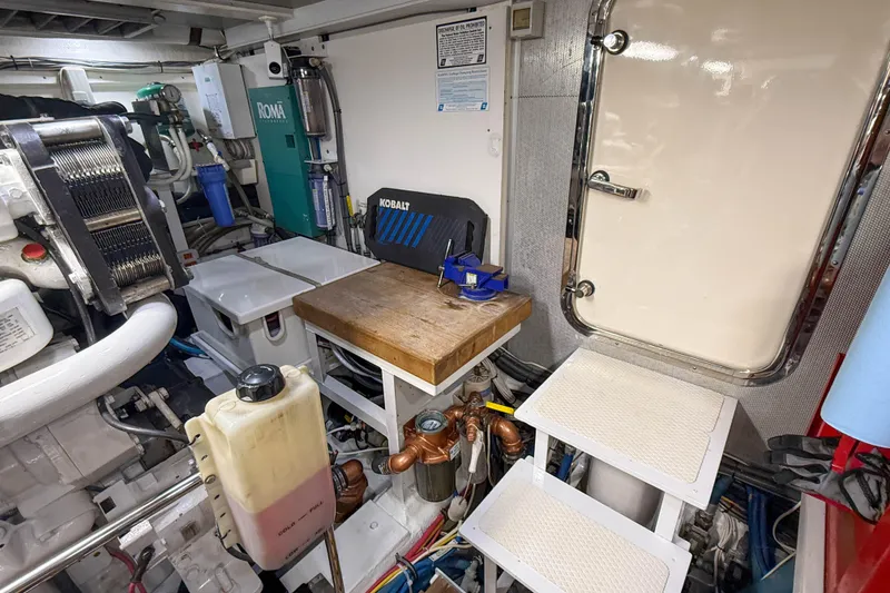 Slide: The Image of Engine room of 2003 Grand Banks 64 Aleutian RP with red tool chest and access door. - 80