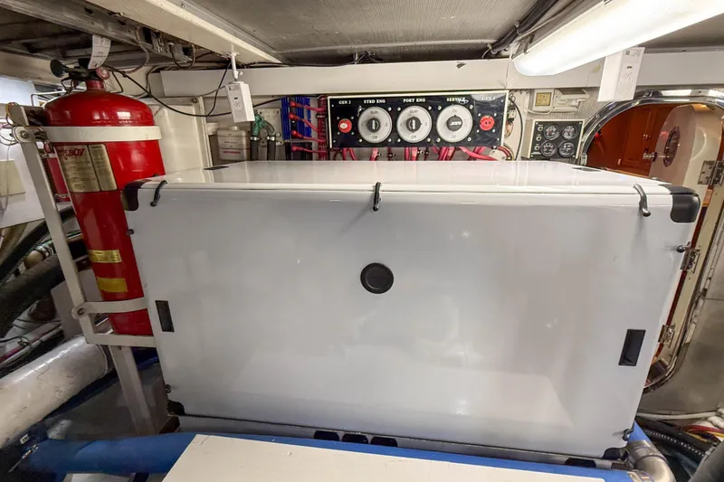 Slide: The Image of Engine room of 2003 Grand Banks 64 Aleutian RP yacht, featuring control panels and equipment. - 82