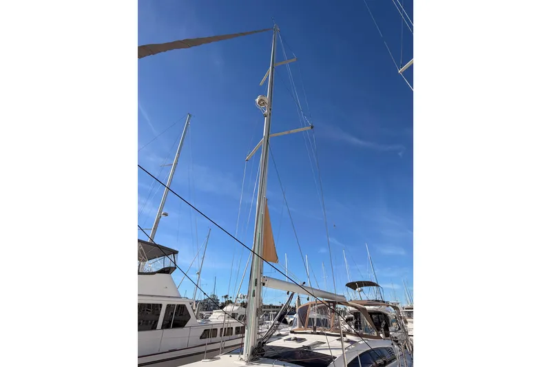 Slide: The Image of 2011 Jeanneau 53 sailboat with tall mast against clear blue sky. - 12