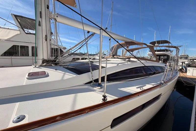 Slide: The Image of 2011 Jeanneau 53 sailboat docked at marina under clear blue sky. - 14