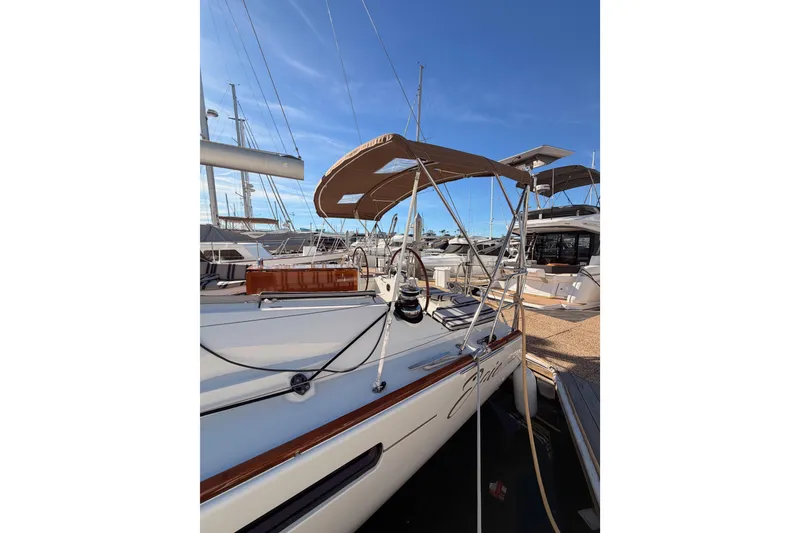 Slide: The Image of 2011 Jeanneau 53 sailboat docked at marina under clear blue sky. - 16