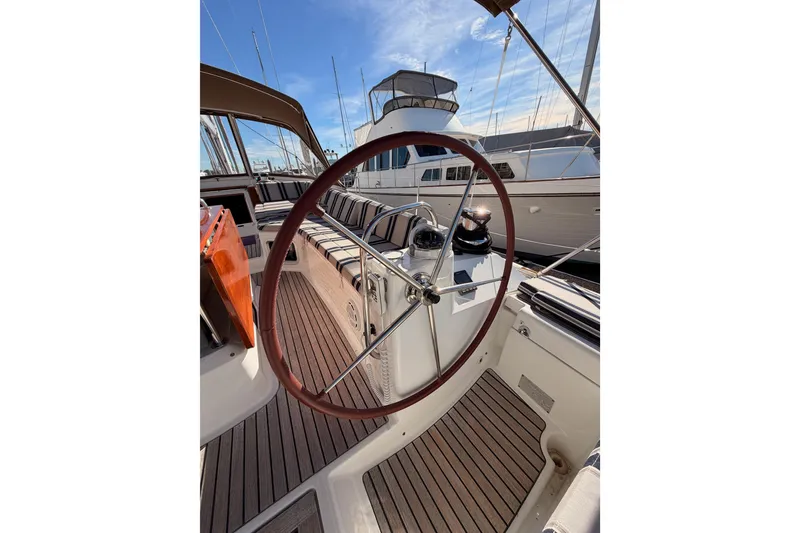 Slide: The Image of Steering wheel of a 2011 Jeanneau 53 yacht, docked at a marina. - 20