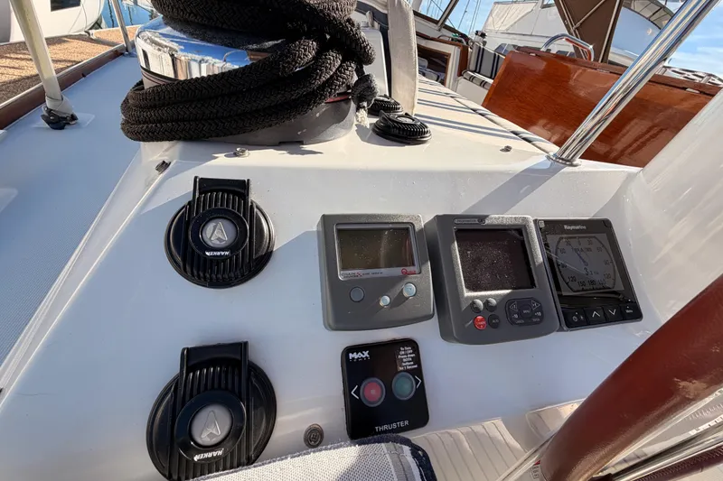 Slide: The Image of Control panel of a 2011 Jeanneau 53 sailboat with navigation instruments and winch. - 24