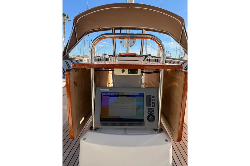 Slide: The Image of Cockpit of 2011 Jeanneau 53 sailboat with navigation equipment and wooden finish. - 25