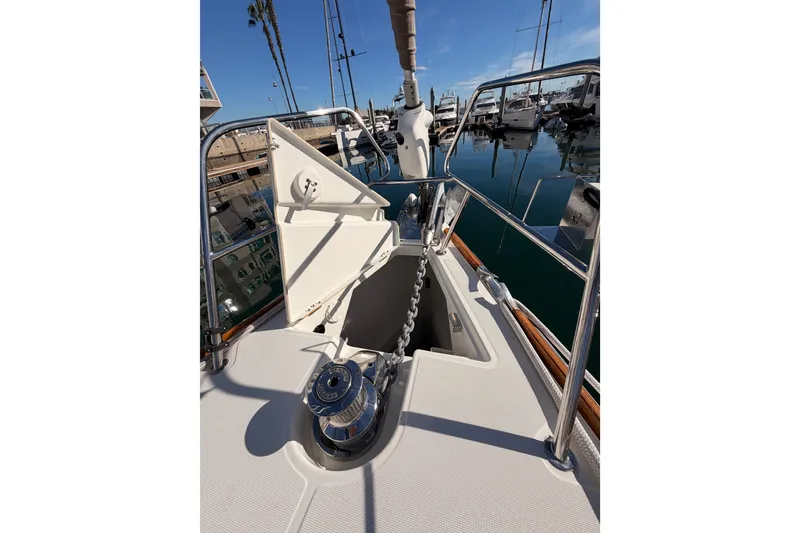 Slide: The Image of 2011 Jeanneau 53 yacht anchor chain and winch on deck in marina. - 32