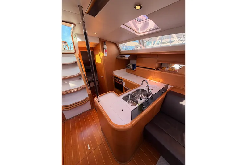 Slide: The Image of Interior of 2011 Jeanneau 53 yacht featuring modern kitchen and seating area. - 43