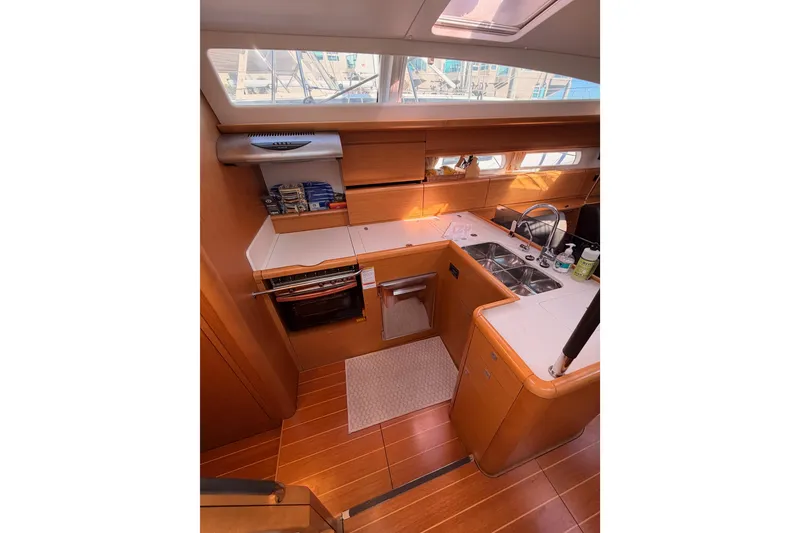 Slide: The Image of Interior of 2011 Jeanneau 53 yacht kitchen with wood finish and modern appliances. - 44