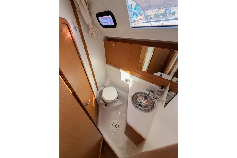 Slide: The Image of 2011 Jeanneau 53 yacht bathroom with sink, toilet, and mirror. - 48