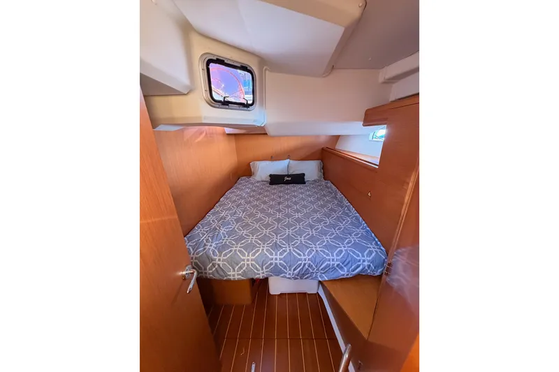 Slide: The Image of Cozy cabin interior of 2011 Jeanneau 53 yacht with bed and porthole. - 49