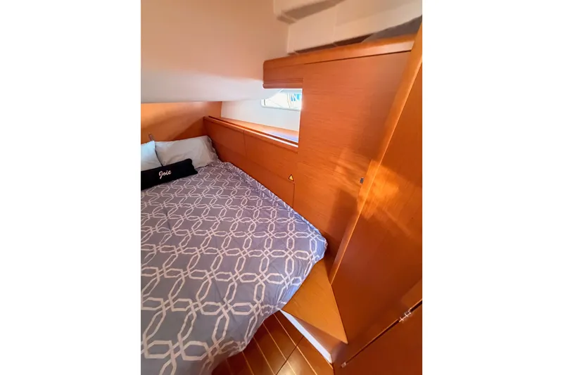 Slide: The Image of Cozy cabin interior of 2011 Jeanneau 53 yacht with patterned bedding. - 51