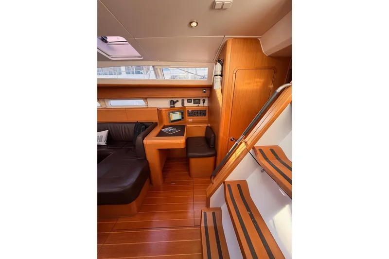 Slide: The Image of Interior of 2011 Jeanneau 53 yacht with wooden flooring and seating area. - 54