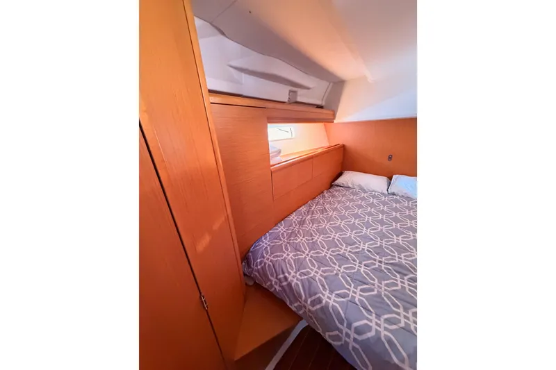 Slide: The Image of Cozy cabin interior of 2011 Jeanneau 53 sailboat with patterned bedding. - 59