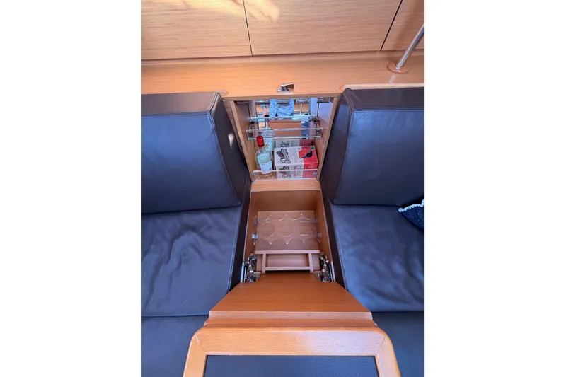 Slide: The Image of Interior of 2011 Jeanneau 53 yacht with built-in storage and seating area. - 66