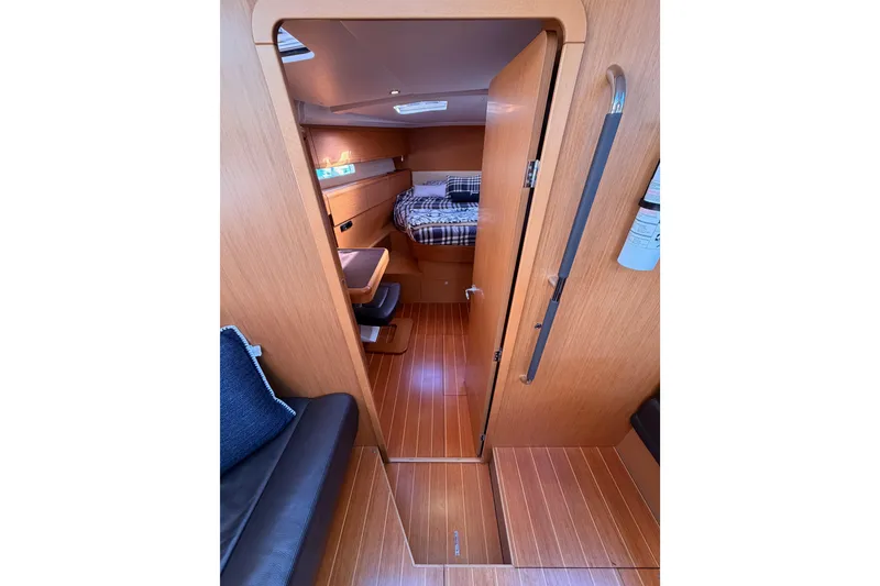 Slide: The Image of Interior of 2011 Jeanneau 53 yacht, featuring cozy cabin with wooden finish and seating area. - 69