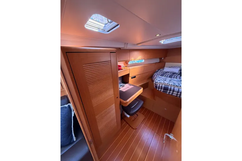 Slide: The Image of Cozy cabin interior of 2011 Jeanneau 53 yacht with wooden furnishings and skylight. - 70