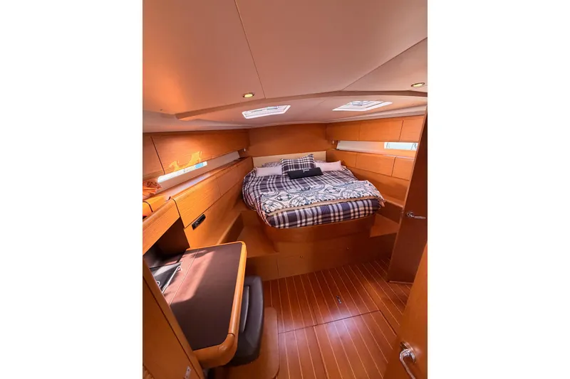 Slide: The Image of Luxurious cabin interior of 2011 Jeanneau 53 yacht with cozy bed and wooden finish. - 71