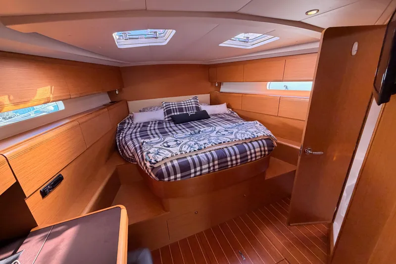 Slide: The Image of Luxurious 2011 Jeanneau 53 yacht cabin with cozy bed and elegant wood finish. - 72