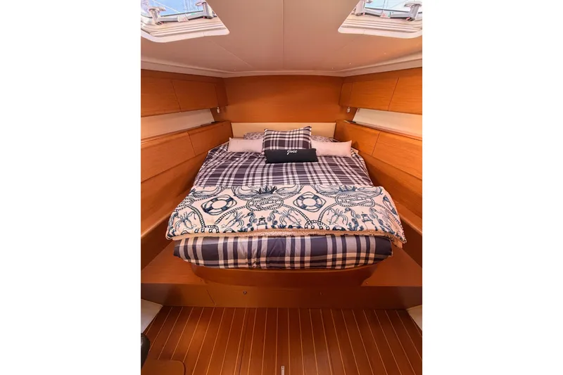 Slide: The Image of Cozy cabin interior of 2011 Jeanneau 53 yacht with plaid bedding and nautical decor. - 73