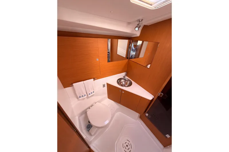 Slide: The Image of 2011 Jeanneau 53 yacht bathroom with modern fixtures and wooden cabinetry. - 75