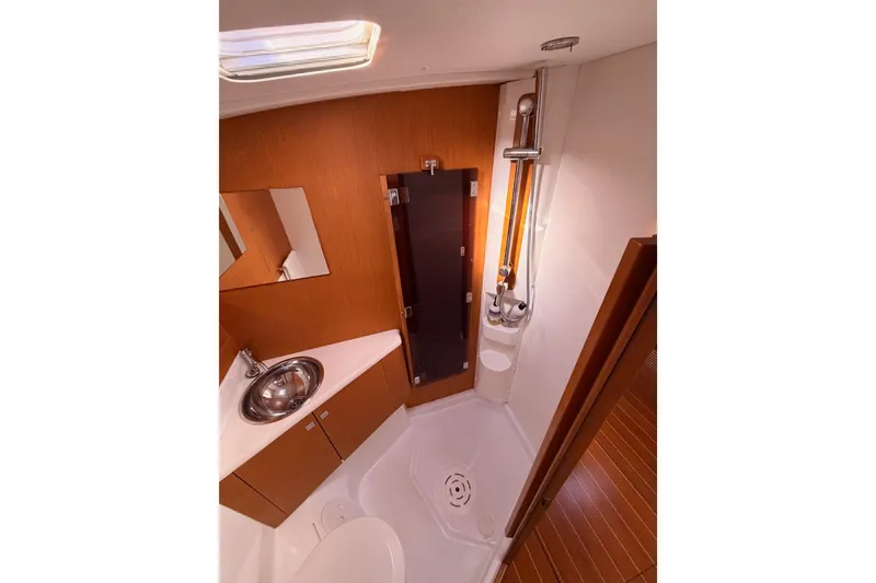Slide: The Image of Luxurious bathroom in 2011 Jeanneau 53 yacht with modern fixtures and wooden cabinetry. - 76