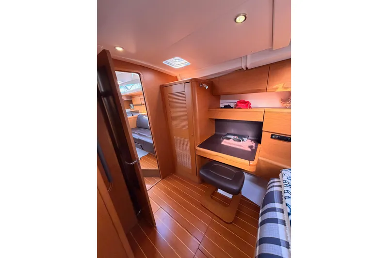 Slide: The Image of Interior of 2011 Jeanneau 53 yacht, featuring wooden flooring and cozy seating area. - 78