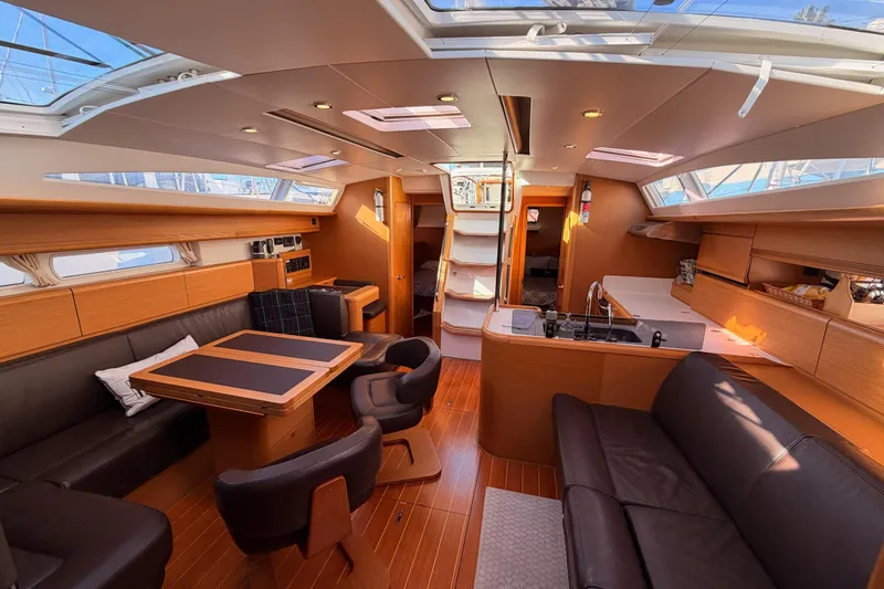 Slide: The Image of Luxurious interior of a 2011 Jeanneau 53 yacht with modern furnishings and ample natural light. - 79