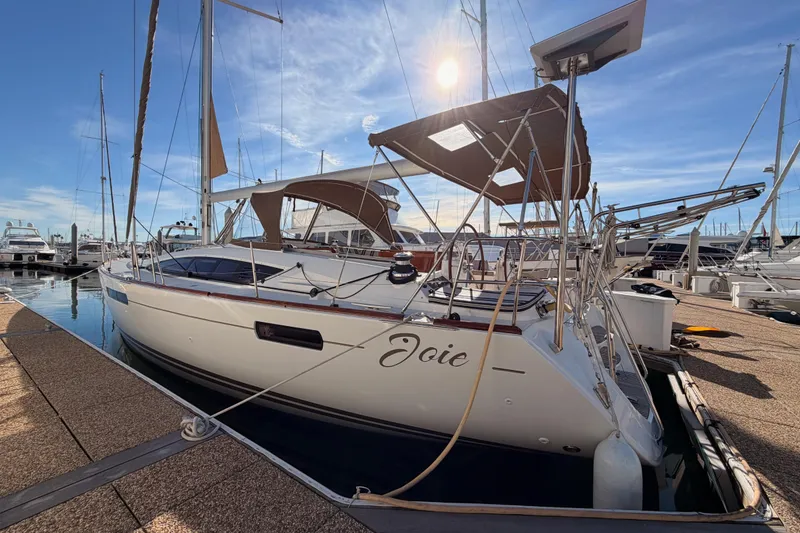 Slide: The Image of 2011 Jeanneau 53 sailboat docked in marina under clear blue sky. - 8